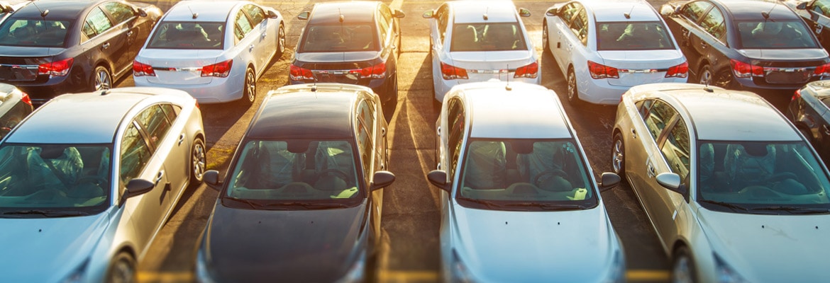 A variety of vehicles sitting on a lot.