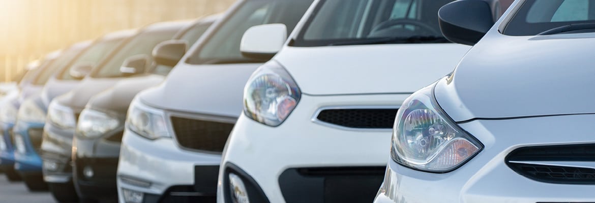 Front view of cars lined up on a dealership lot