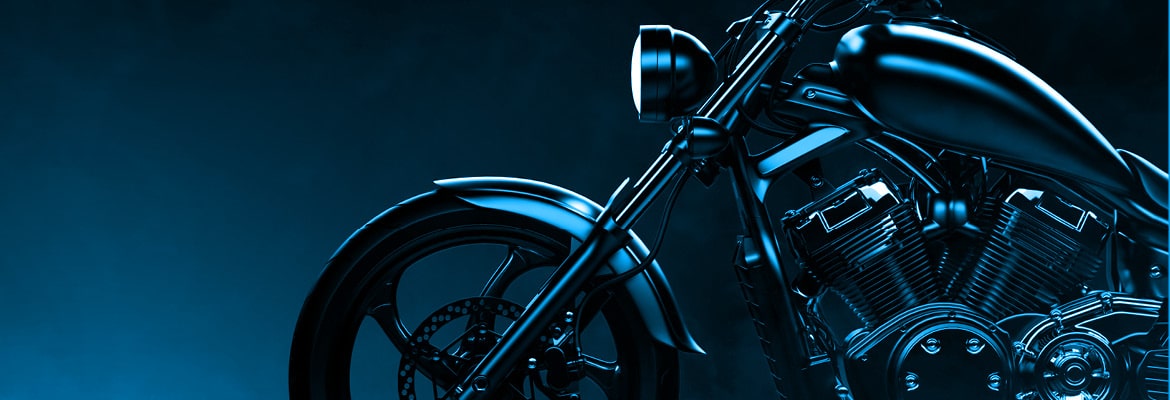 Close up photo of a motorcycle on a black and blue background