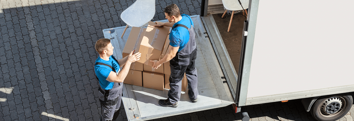 Photo of professional movers loading boxes into a moving truck.