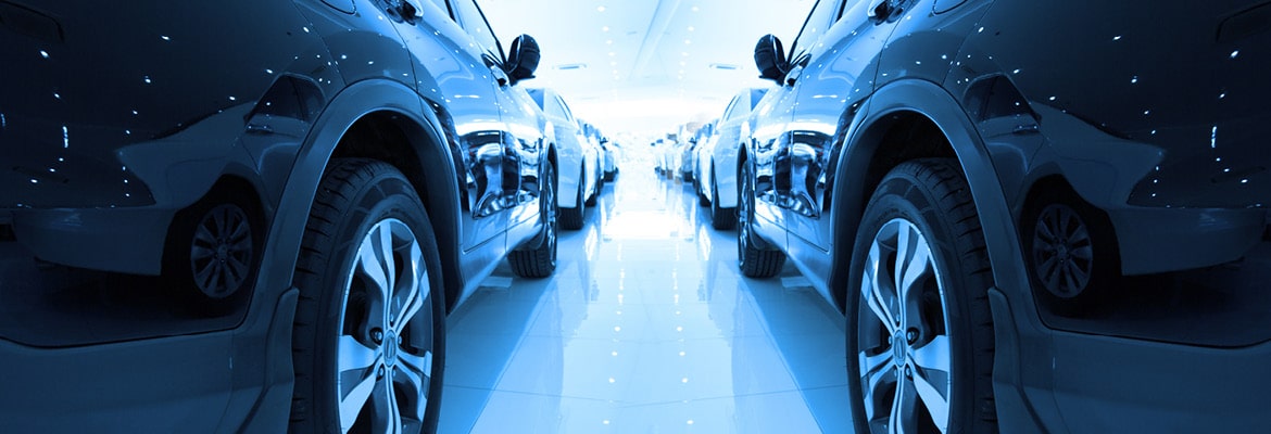 Cars on display inside of a dealership.