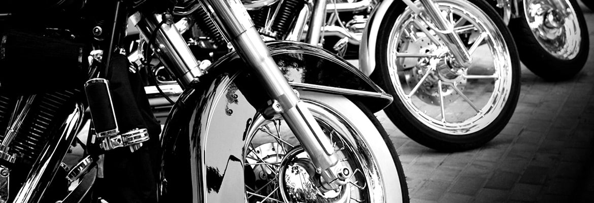 Close-up, black and white photo of motorcycle wheels