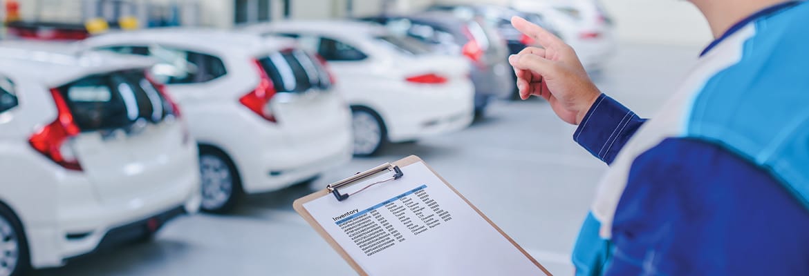 Dealer taking inventory of vehicles