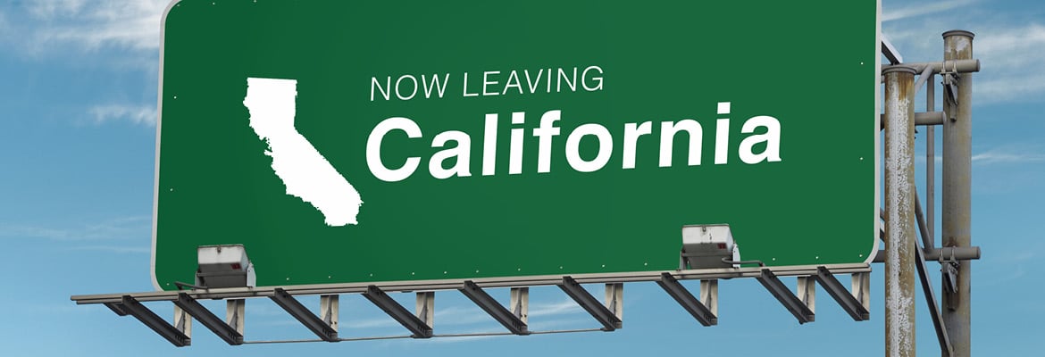 Green road sign reading "Now Leaving California"