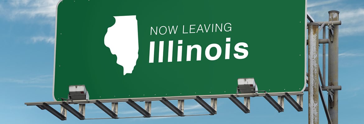 Green road sign that reads "Now leaving Illinois"