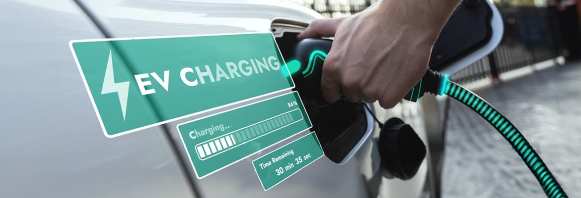 Closeup of a person putting a charger into an electric vehicle