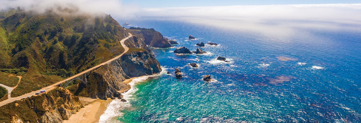 High-level view of the ocean and mountain coastline.