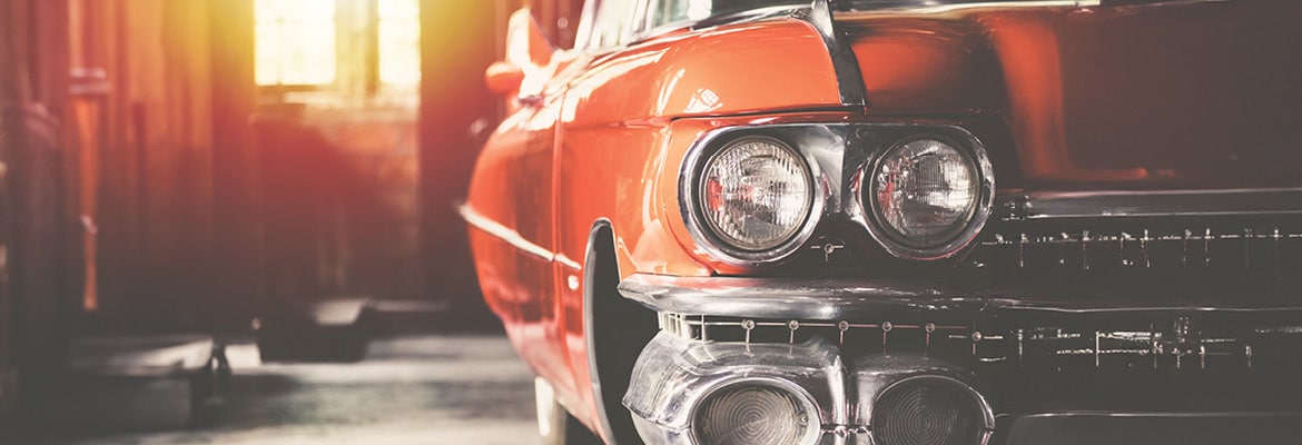 Photo of a red classic car stored in a garage