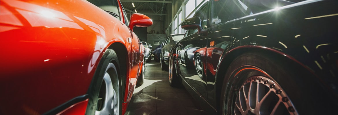 Close up photo of luxury vehicles parked in a garage or storage area