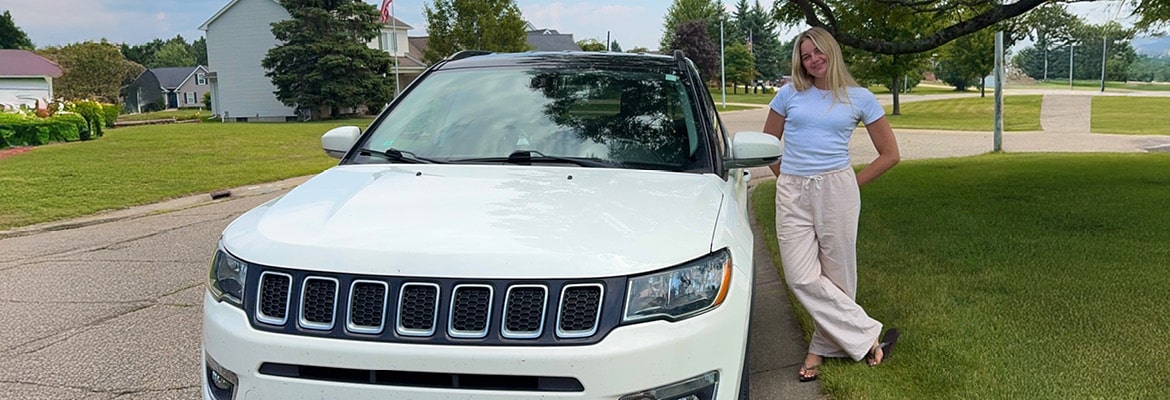 Montway customer Meredith Good standing by her 2020 Jeep Compass after it was transported.