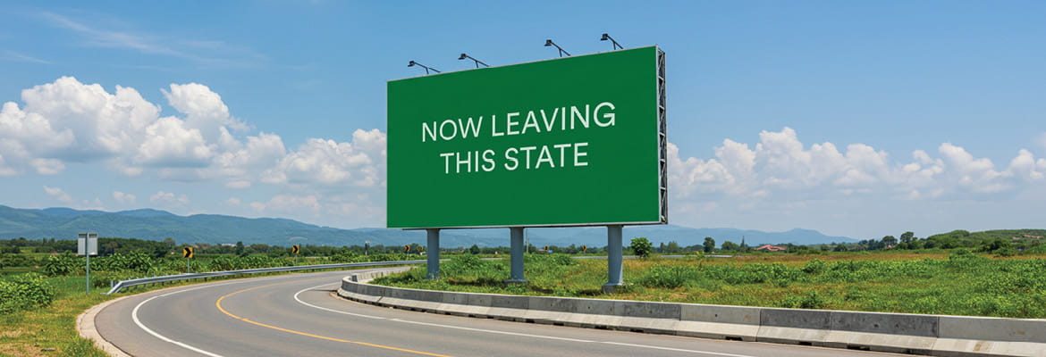 interstate sign displaying leaving a state