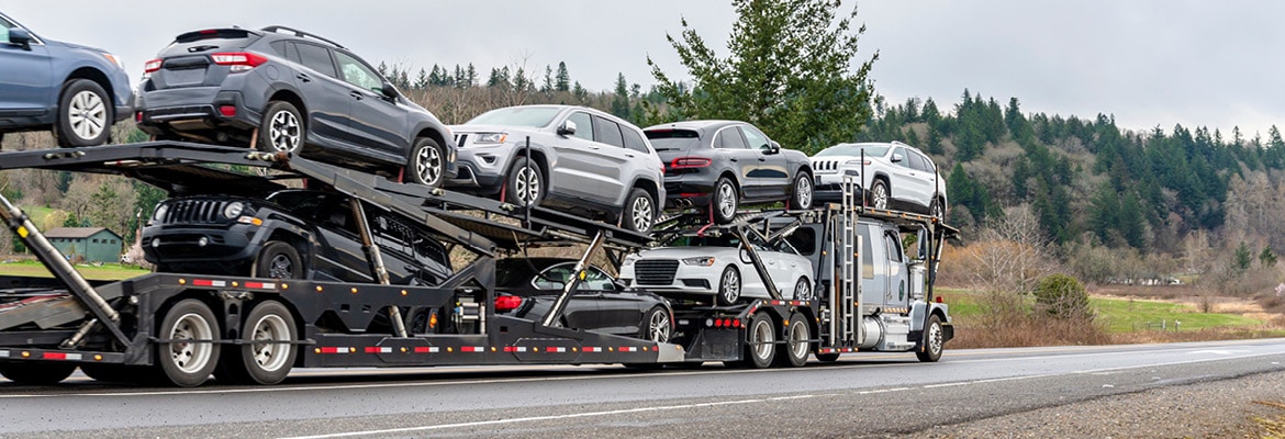 Open car carrier shipping full load of vehicles.