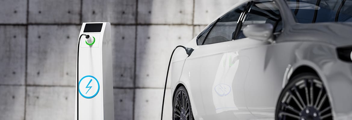 New electric vehicle from manufacturer at charging station.
