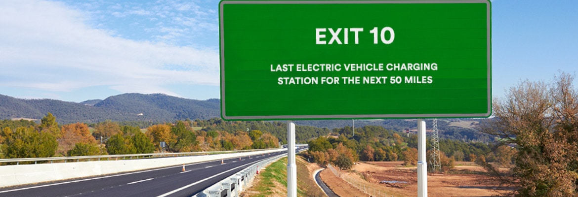 Green exit sign for last electric vehicle charging station in rural America.