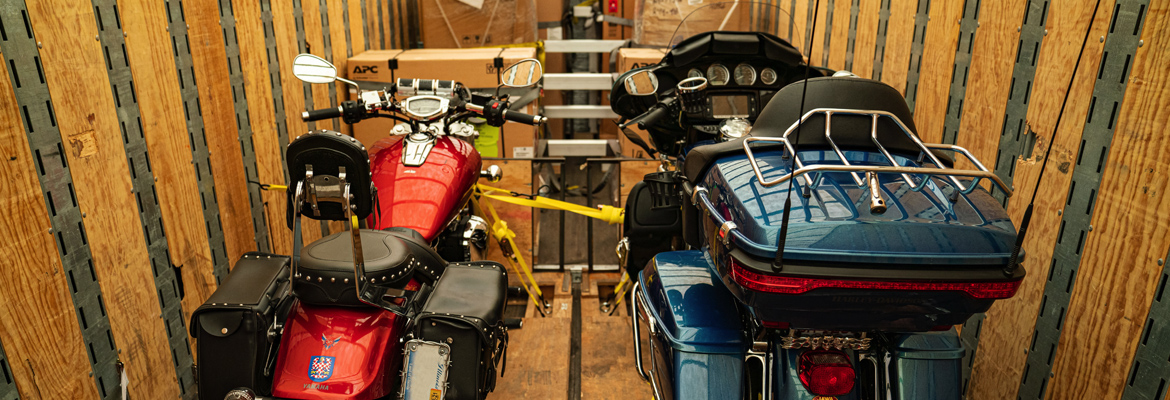 Two motorcycles being shipped in enclosed carrier.
