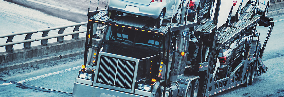 Open car carrier transporting vehicles.