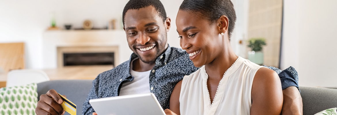 Couple using AutoTrader to buy a used car online.